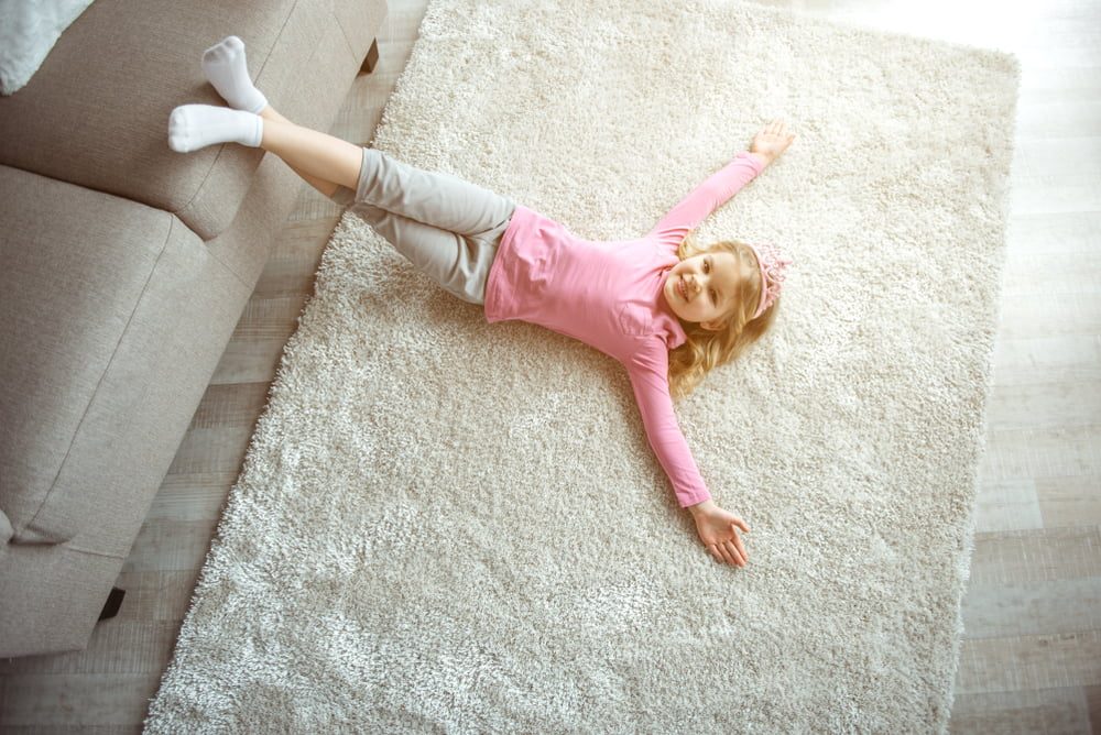 criança deitada no tapete